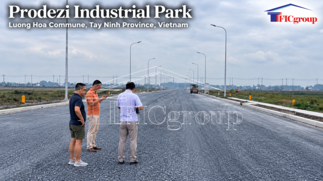 Main internal transportation corridor at Prodezi Industrial Park, Luong Hoa Commune, Tay Ninh Province, Vietnam, with visitors inspecting road infrastructure
